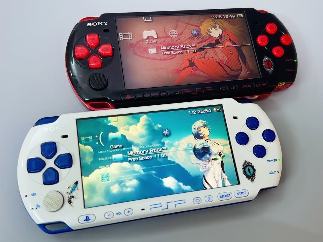 Two Evangelion-designed PSPs, one in white and blue and one in red and black