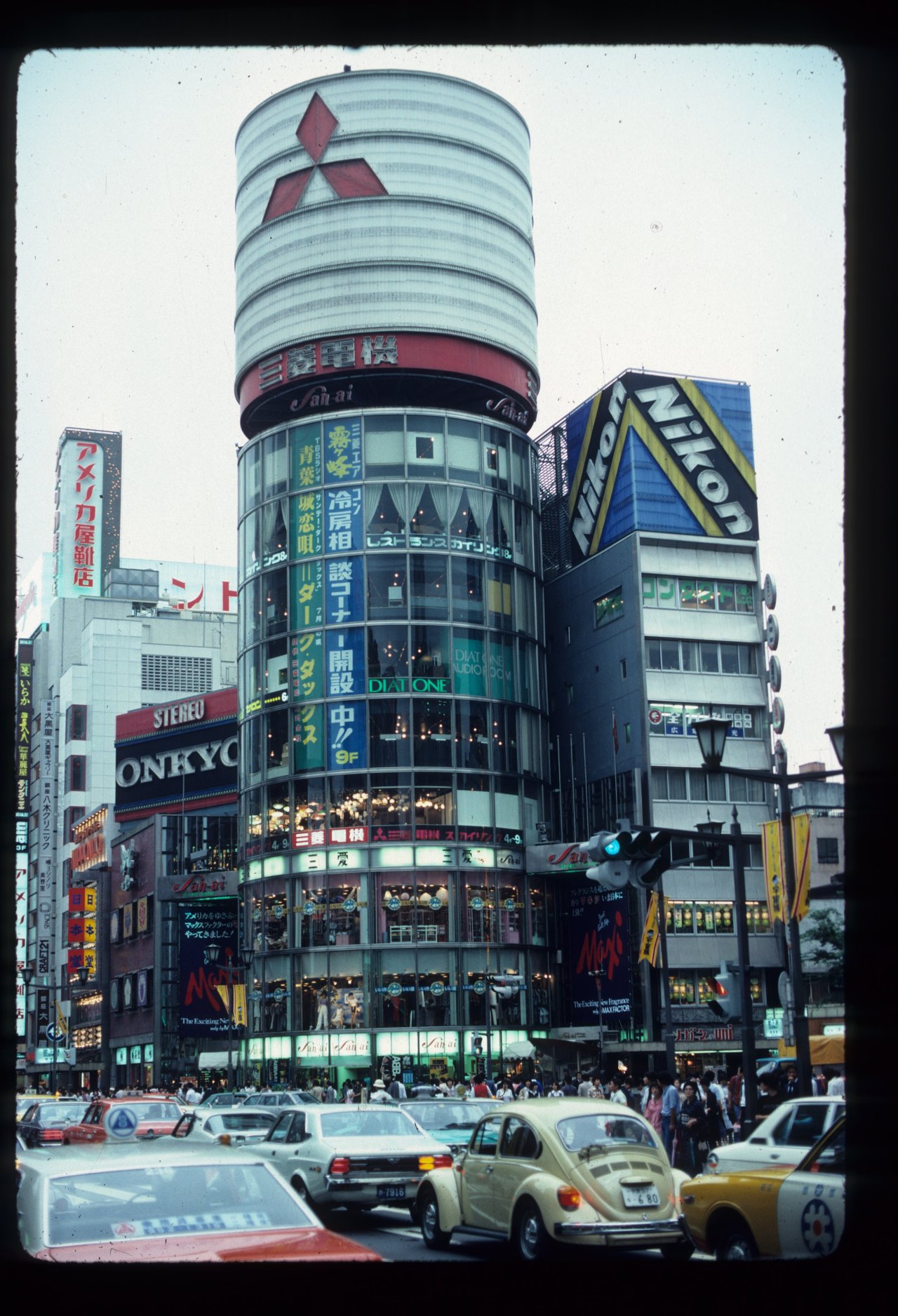 The Mitsubishi Tower with cars driving on the road in front of it