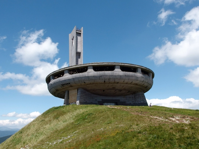 a brutalist building in Bulgaria, on top of a hill