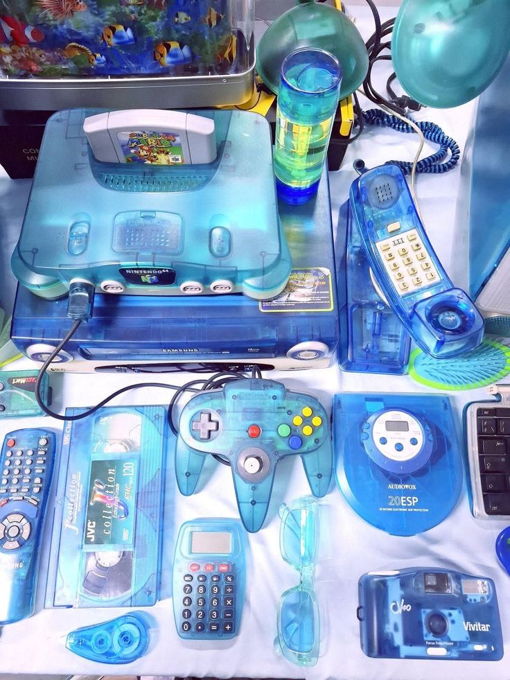 a bunch of blue transparent tech including a N64, VHS tape, corded phone, and CD player