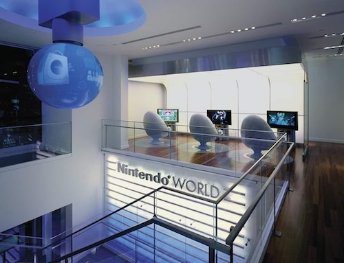 a view of Nintendo World with three futuristic pod chairs facing TV screens