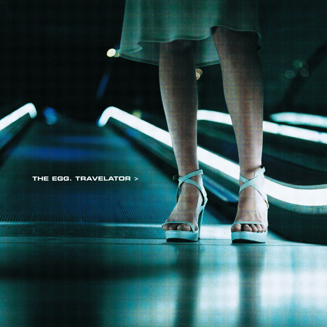 an album cover showing the legs of a woman standing near a travelator